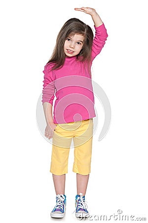 Serious little girl showing her height Stock Photo