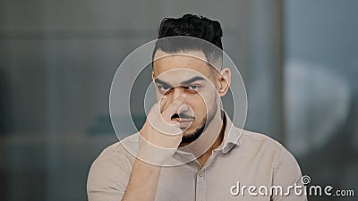 Serious man arabian worker entrepreneur upset nodds head pointing fingers on both eyes showing watching you gesture Stock Photo