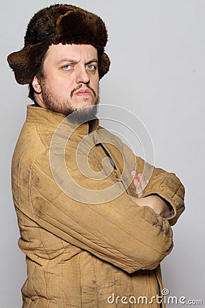 Serious man in hat. Old winter clothing. Stock Photo