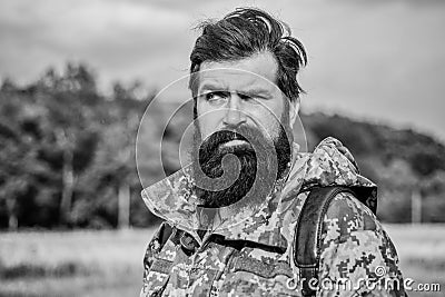 Serious man. soldier in military uniform. brutal male poacher. male beard care. bearded man hiking with backpack. mature Stock Photo