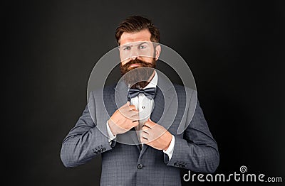 serious man in tuxedo neck tie. man in formalwear on black background. male formal fashion Stock Photo