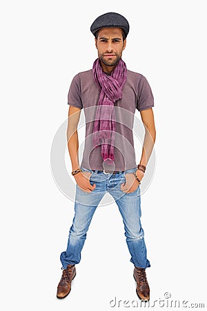 Serious man wearing peaked cap and scarf looking at camera Stock Photo