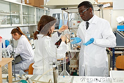 Serious man and woman lab technicians discussing about results of experiments Stock Photo