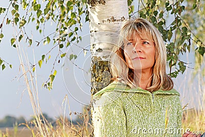 Serious mature woman relaxing in nature Stock Photo