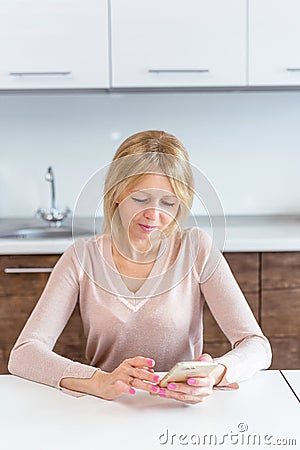 Serious middle age businesswoman using a smartphone Stock Photo