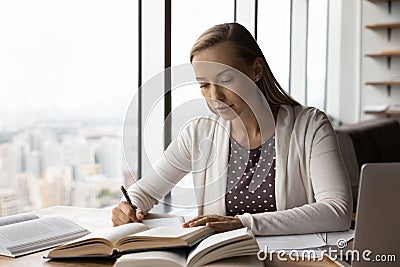 Smart female handwrite study online with books Stock Photo
