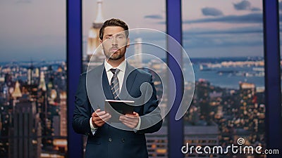 Serious newsreader speaking newscast evening television studio close up. Stock Photo