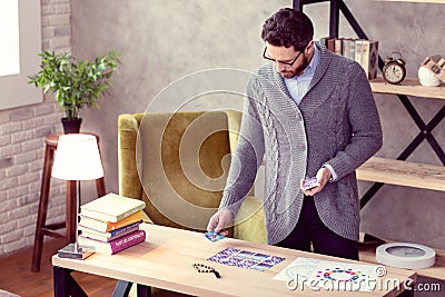 Serious nice man holding a pack of cards Stock Photo