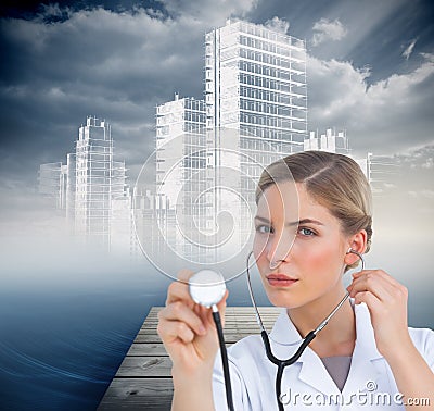 Serious nurse listening with stethoscope Stock Photo