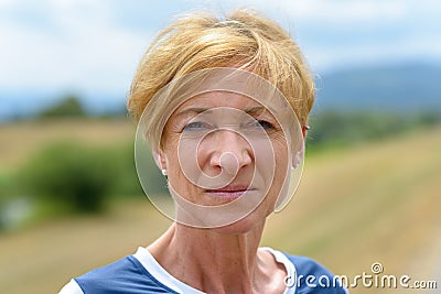 Serious pretty blond middle-aged woman Stock Photo