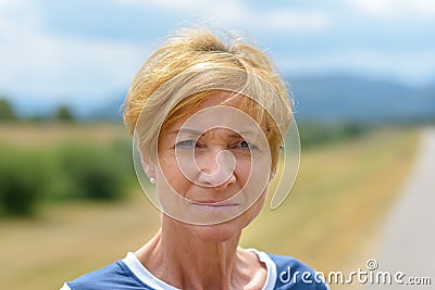 Serious pretty blond middle-aged woman Stock Photo