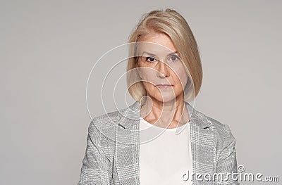 Serious senior blonde woman. Isolated Stock Photo