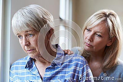 Serious Senior Woman With Adult Daughter At Home Stock Photo