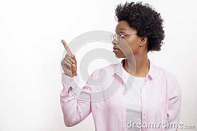 Serious severe female looking aside and makinng observation with finger Stock Photo