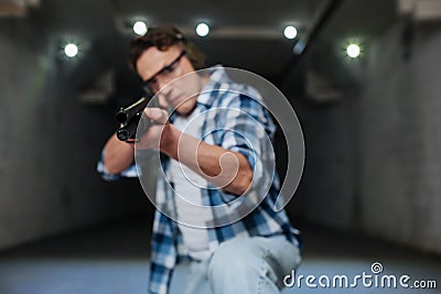 Serious skilled marksman shooting at you Stock Photo