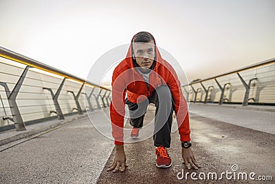 Determined sportive young man standing on a footbridge Stock Photo