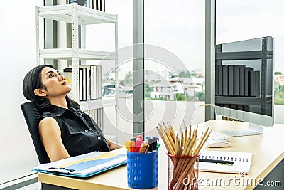 Serious stressed business woman sitting sad and thinking hard how to solve problem in office company bankruptcy Stock Photo