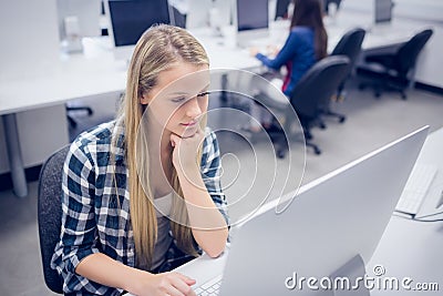 Serious student working on computer Stock Photo