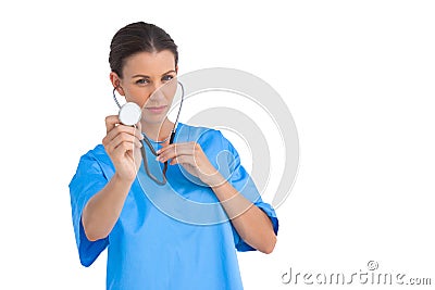 Serious surgeon holding up stethoscope Stock Photo