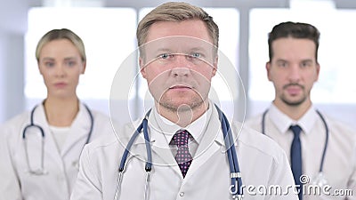 Serious Team of Doctors Looking at the Camera Stock Photo