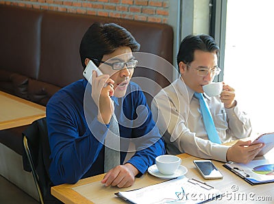 Serious Two Businessman using moblie phone Stock Photo