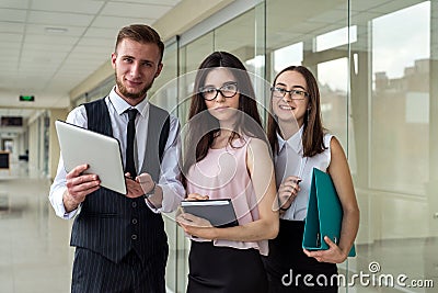 Serious two businesswoman and men show document and talk about mistake to subordinate in office Stock Photo