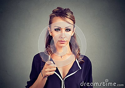 Serious woman pointing at camera Stock Photo