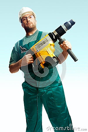 Serious workman hold perforator in his hands Stock Photo