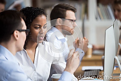 Serious young African American woman talking with colleague Stock Photo