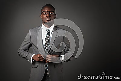 Serious young black man with glasses and gray business suit Stock Photo