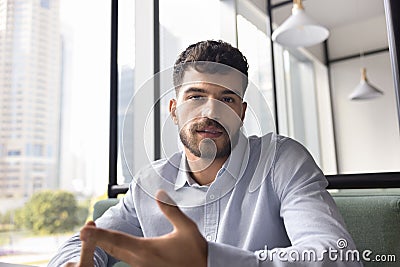 Serious young business professional man talking on video call Stock Photo