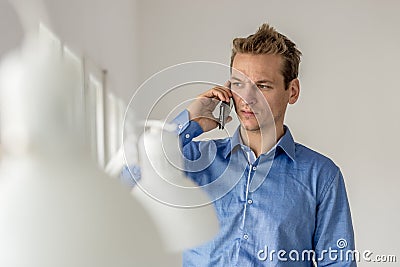 Businessman frowning as he speaks on mobile phone Stock Photo