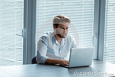 Serious young businessman working on a laptop Stock Photo