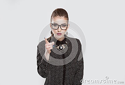 Serious young girl business woman showing index finger for admonition Stock Photo