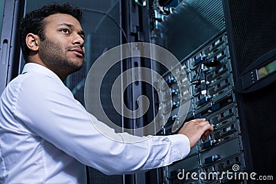 Serious young man working with informational technology Stock Photo