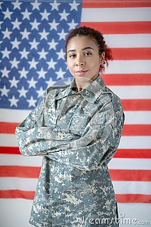 Serious young pretty servicewoman wearing camouflage uniform Stock Photo