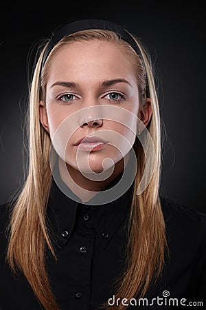 Serious young woman in black Stock Photo