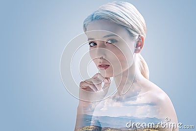 Serious young woman posing against natural background Stock Photo