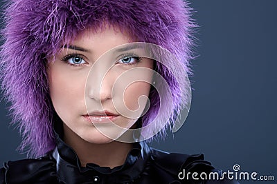 Serious young woman in purple wig Stock Photo