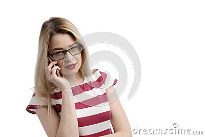 Serious young woman talking on phone isolated on white. Copy space and fashion. Beautiful and happy European woman talking on the Stock Photo