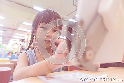 Seroius girl is using Tablet in classroom Stock Photo