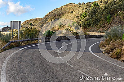 Serpentine road to Ronda town among rocky mountains in Andalusia, Spain Stock Photo