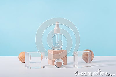 Serum cosmetic bottle with peptides and retinol on acrylic and wooden blocks on pink background. Oil cosmetics Stock Photo