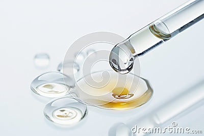 Serum dropper and skin care cosmetics product drop close-up on white background Stock Photo