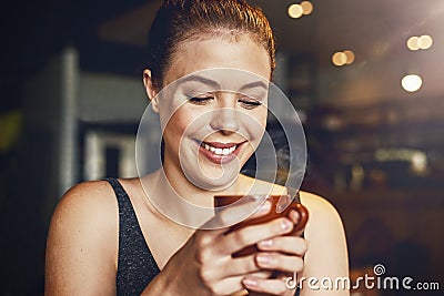 They serve better coffee than anyone down the road. a young woman having a cup of coffee in a cafe. Stock Photo