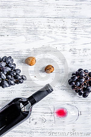 Serve wine. Bottle, glass, nuts and grape on wooden table background top view copyspace Stock Photo