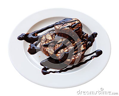 Served chocolate rolled cake with walnut on plate Stock Photo