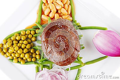 Served meat medalion on beans Stock Photo