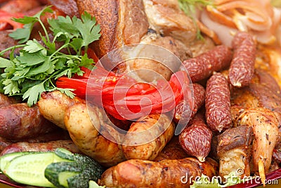 Served meat plate with grilled sausages and vegetables sliced Stock Photo