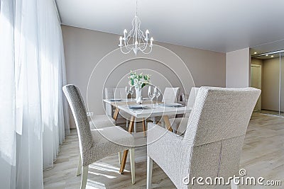 Served table with a bouquet of roses in interior of modern luxure guest room in studio apartments in minimalistic style Stock Photo